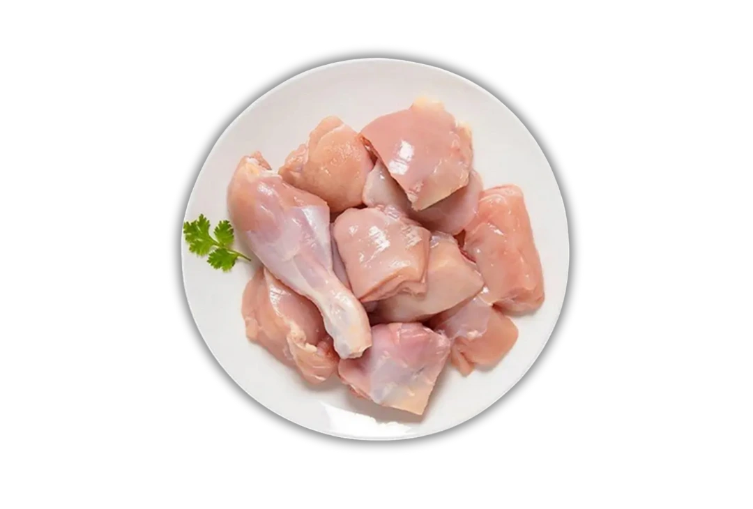 Plate of fresh, pink, raw chicken curry cut pieces with skinless drumsticks and breast pieces. Order fresh halal chicken online from Seohara Express in Seohara, Bijnor.